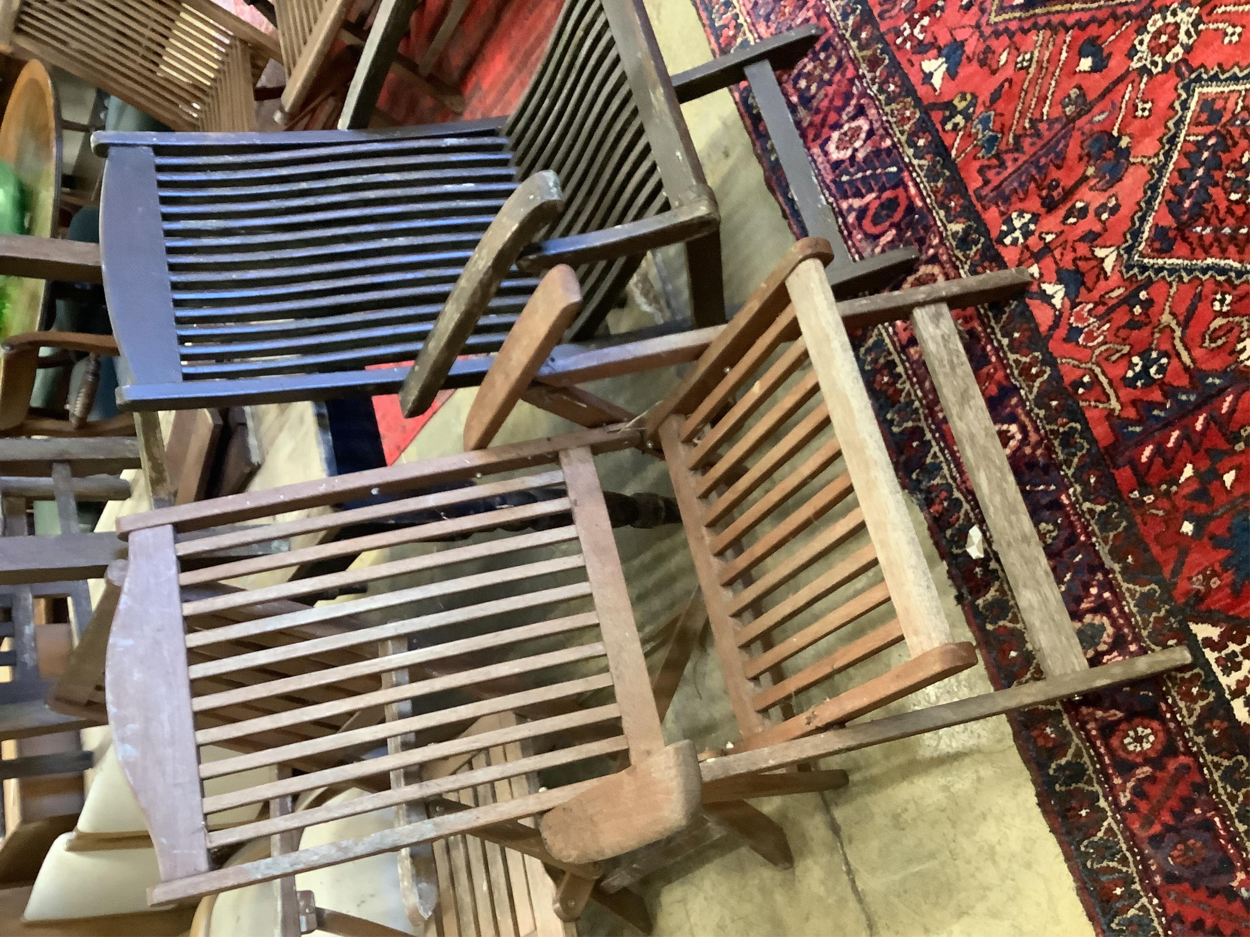 Three various teak folding garden elbow chairs together with two other teak garden chairs